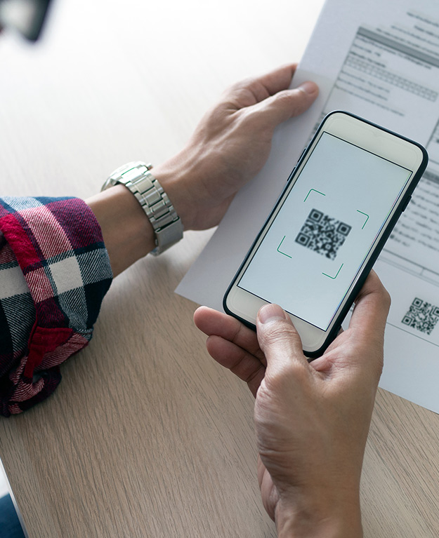 Someone scans a QR-code from a bill with his smartphone